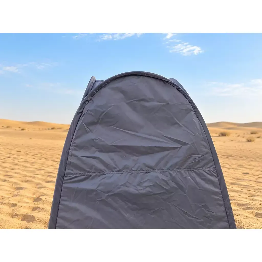 ALGHAFA grey pop-up toilet tent with silver reflective interior and zipped door in the desert