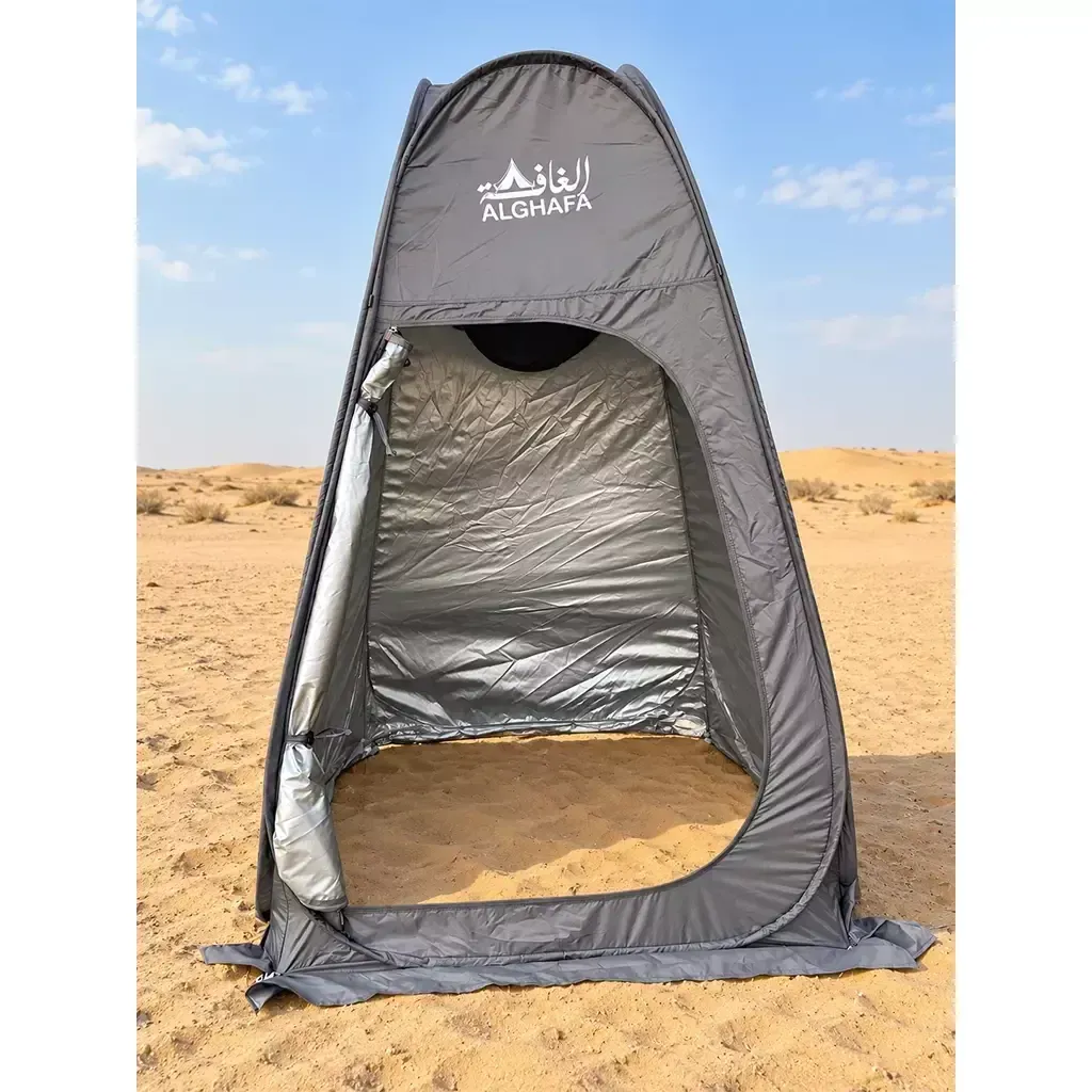 ALGHAFA grey pop-up toilet tent with silver reflective interior and zipped door in the desert